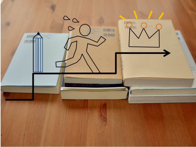 机の上に置かれた複数の参考書と王冠に向かって走る人のイラスト