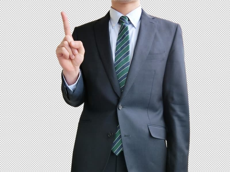 人差し指を立てるスーツの男性